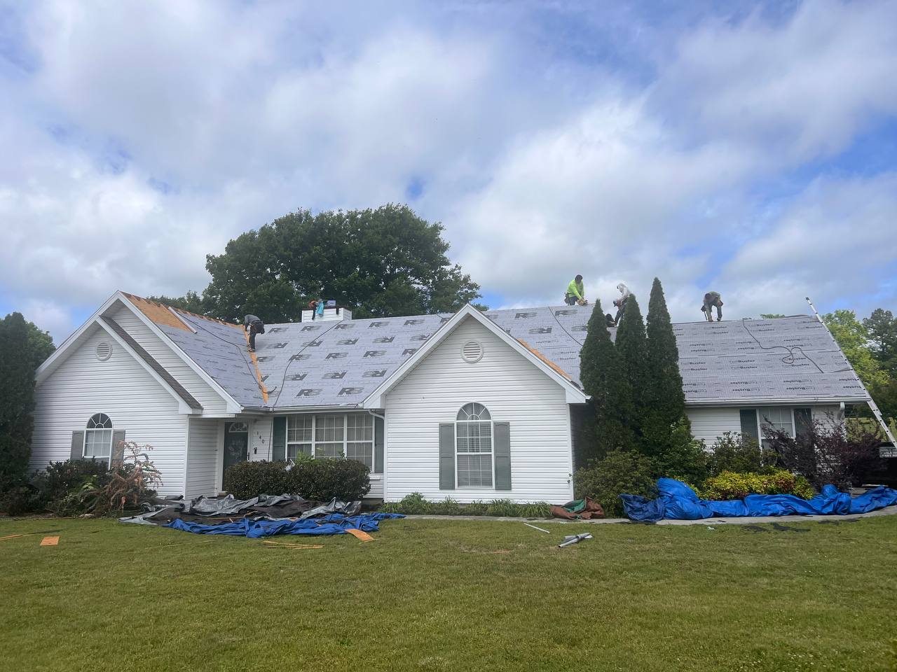 Crew installing synthetic underlayment on a residential roof in Athens, TN