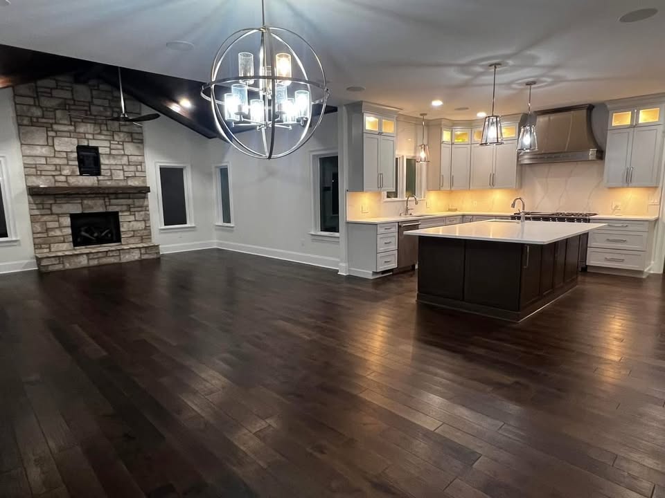 Open-concept kitchen and great room with stone fireplace remodel