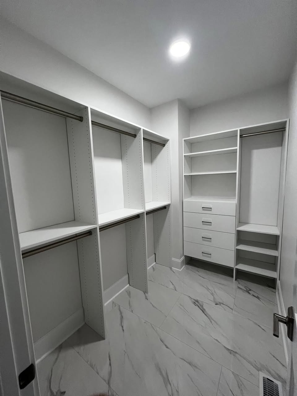 Custom walk-in closet remodel with built-in shelving and marble tile floor by Crockett Construction